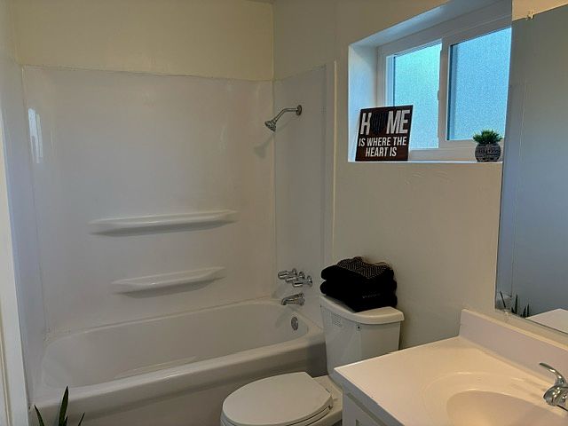 nice updated bathroom
new door, window, mirror, med cabinet, light fixtures, vanity, toilet, and flooring