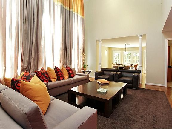 A view from the foyer showing this comfortable, open, inviting living area with the dining room in the background.