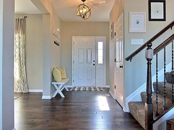 WELCOMING FRONT FOYER OPENS TO A FORMAL DINING AREA OFFERING UPGRADED HARDWOOD FLOORING & UPGRADED LIGHT FIXTURES THROUGHOUT!