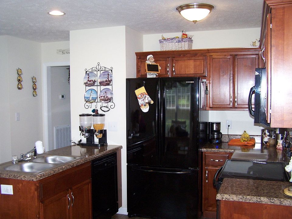 Kitchen with brand new refrigerator.