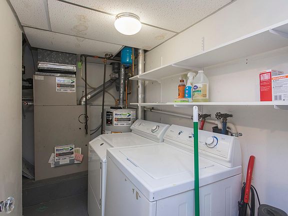 Utility closet with shelving, washer/dryer, HVAC and water heater