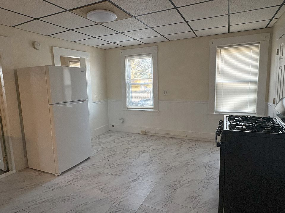 Kitchen with new refrigerator and two large windows
