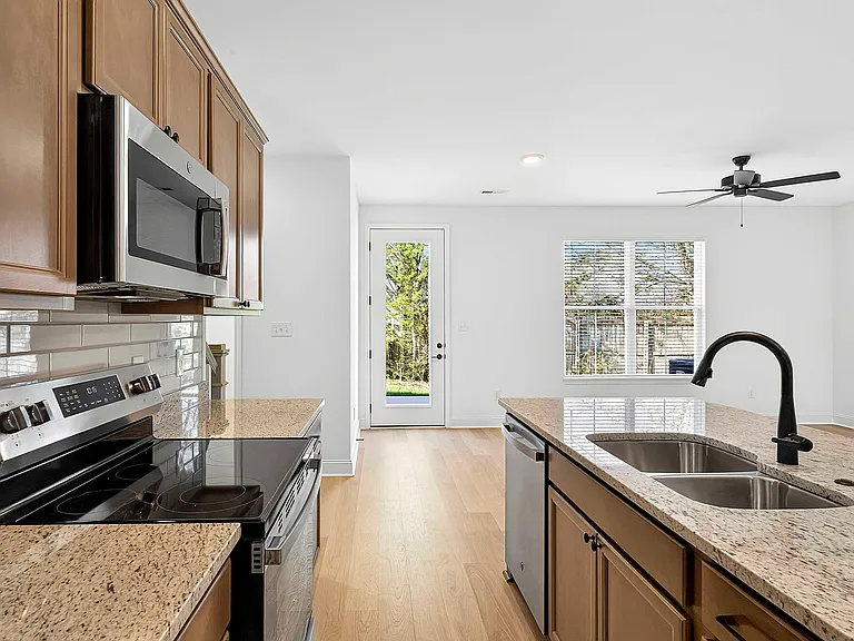 Kitchen with stainless appliances and matte black accessories