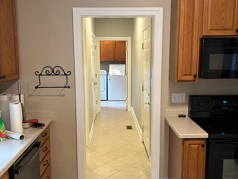Hallway to half bathroom, laundry room, door to garage, hall closet