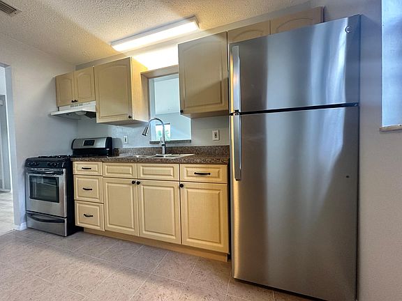 kitchen with a brand new GE refrigerator and gas stove