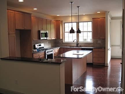 Kitchen
						:
						granite countertops, oversized granite island, maple contemporary cabinets