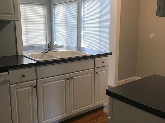 Kitchen opens to bright sunroom