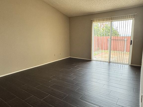 Spacious primary suite features a large walk in closet, bathroom, lots of storage cabinets and access to the backyard. Main area: 15' 5" x 12' 3". Closet: 6' 6" x 5' 9". Entry hall to suite: 8' 10" x 5' 5".