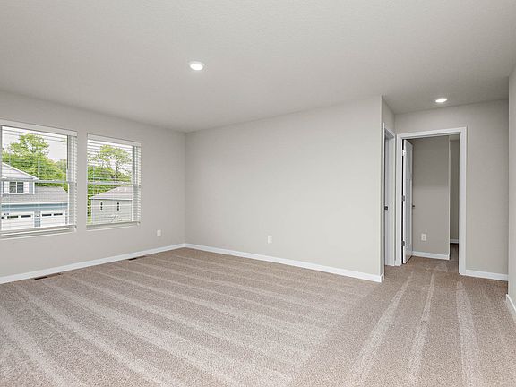 The master bedroom is spacious with a large window