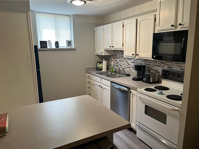 Updated/refreshed kitchen in 2020. Cosmetic upgrades, painted cabinets, new backsplash, new lighting, new paint, new flooring.