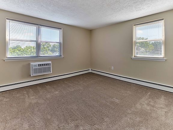 Bright and comfortable carpeted bedroom at Audubon Arms Apartments.
