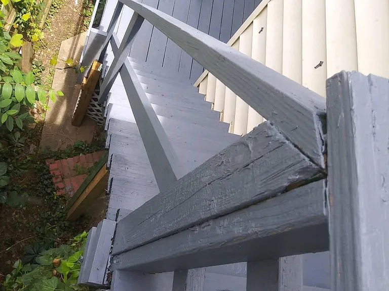 Stairs leading to the Shared Back Porch from the Upstairs Apartment. There is also an Side Entrance Gate from the Side of the Home.