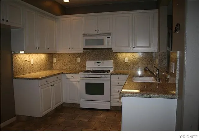 Kitchen with Granite counter tops and cabinets