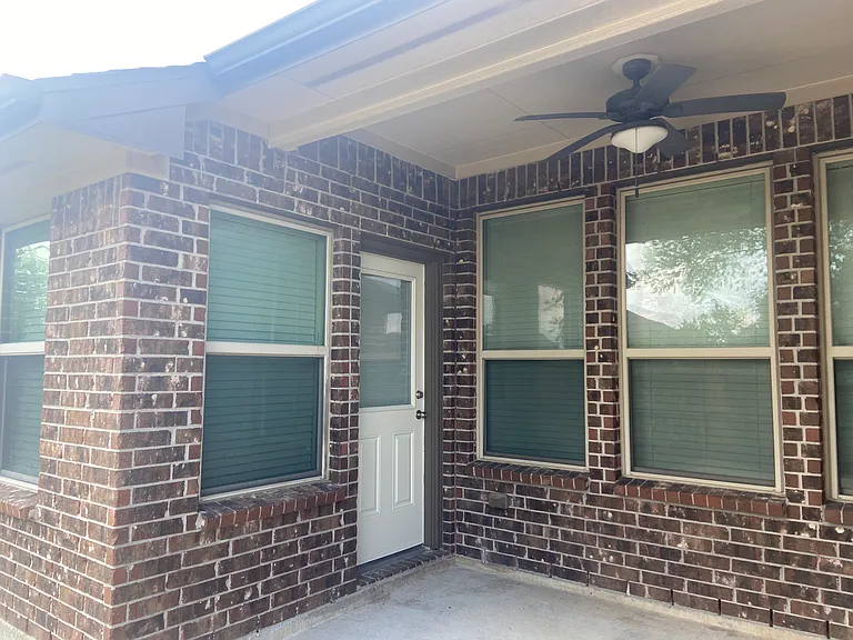 Covered back patio with a ceiling fan _ a shaded, breezy spot to relax year-round.