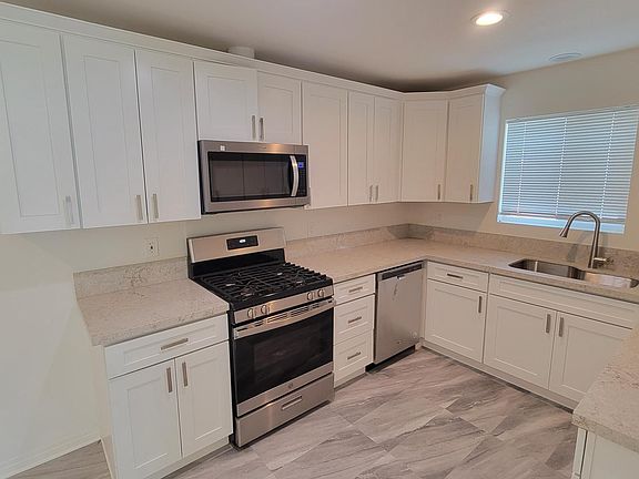 Kitchen with new gas range and microwave