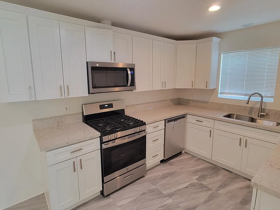 Kitchen with new gas range and microwave