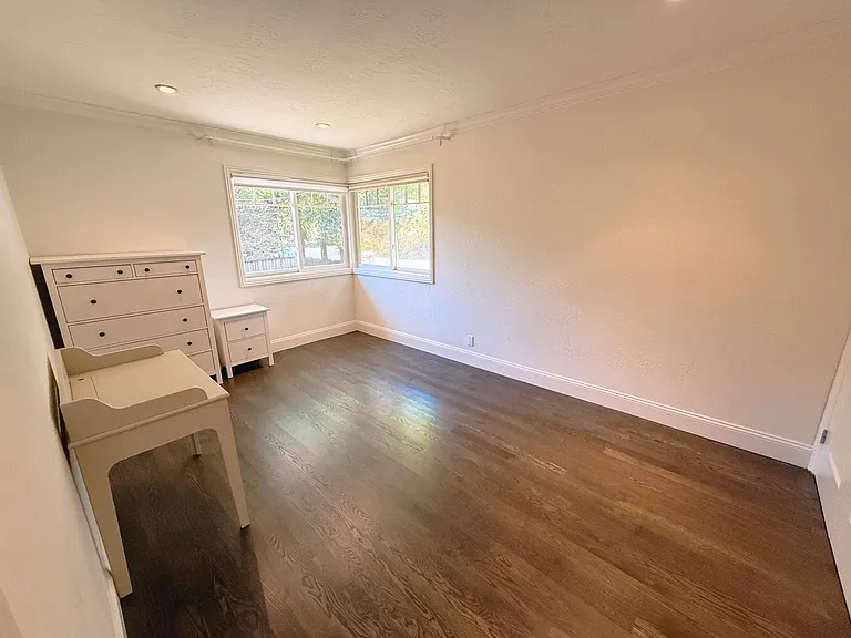 Third bedroom with 2 costom built-in shelf closets
