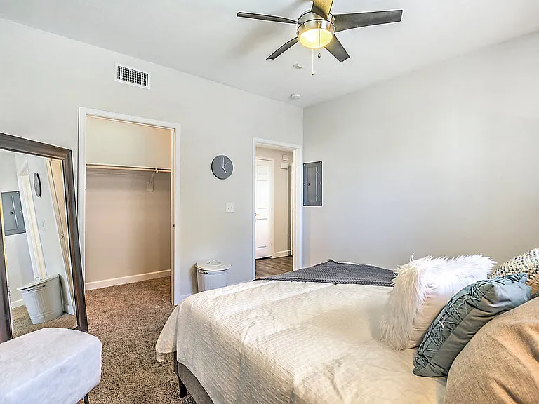 Discover comfort and style at The Michael B: plush carpet, walk-in closets, and ceiling fans for a cozy retreat.