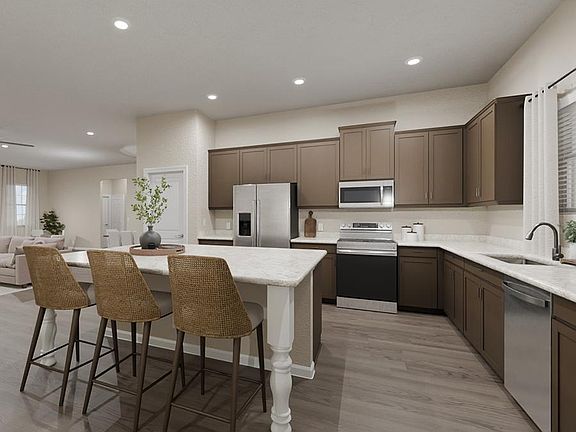 Your new kitchen includes ample cabinet and counter space, a counter-height island, and beautiful fi