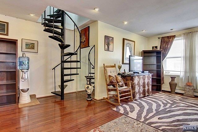 Living room with spiral stairs to private deck