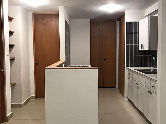 Equipped kitchen from dining room. Laundry room to the back. Left hall to the bedroom and bathroom.