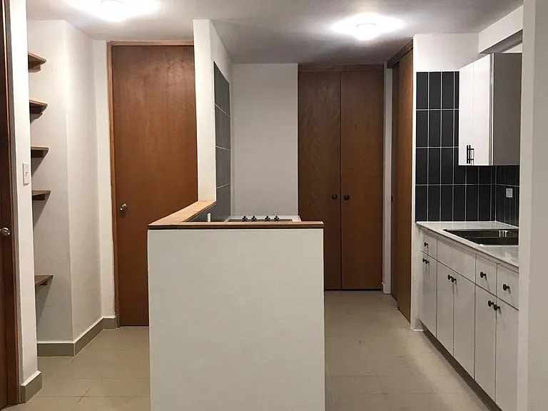 Equipped kitchen from dining room. Laundry room to the back. Left hall to the bedroom and bathroom.