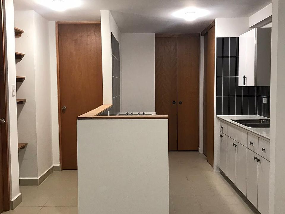 Equipped kitchen from dining room. Laundry room to the back. Left hall to the bedroom and bathroom.