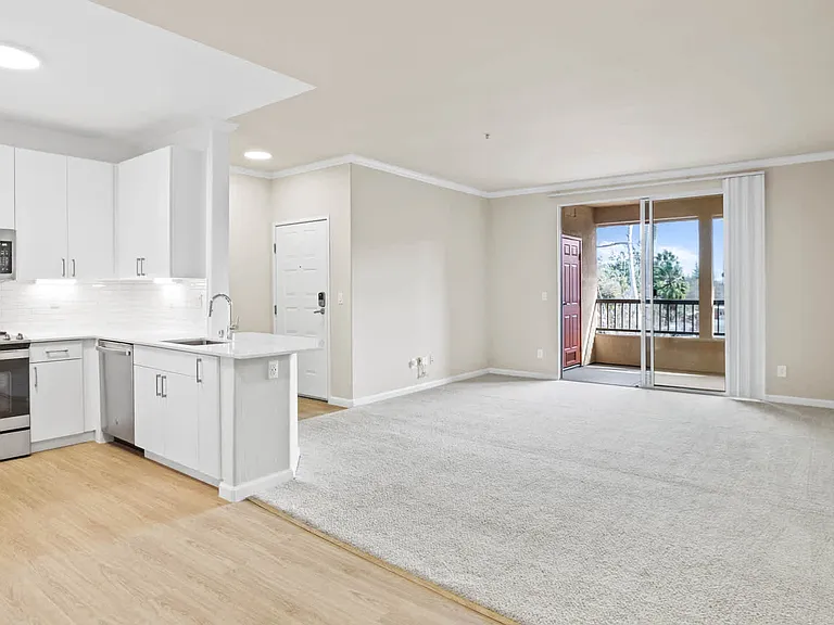 Carpeted Living Room with Balcony