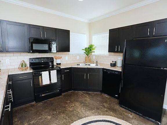 Kitchens featuring marble countertops and ample cabinetry.