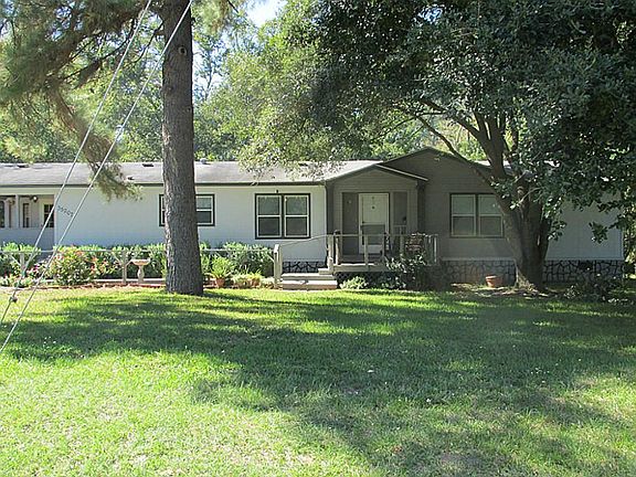 Front of home with large front yard.