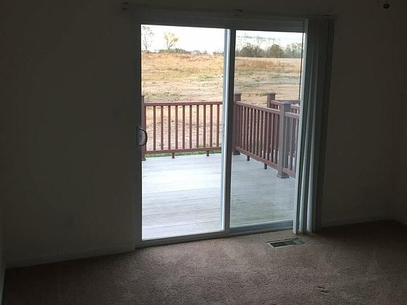 Master bedroom with large closet and patio