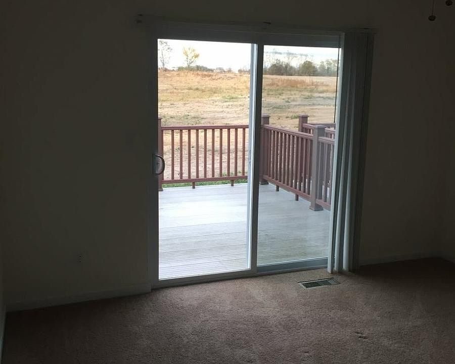 Master bedroom with large closet and patio