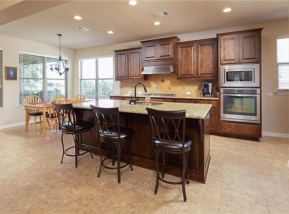 Kitchen upgrades include wood front island and 5 burner stovetop