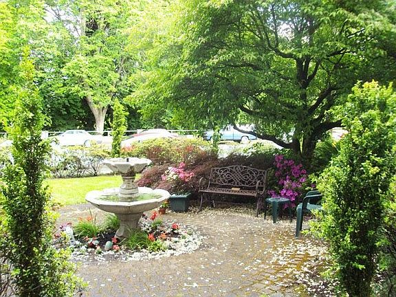Quaint seating area with abundant foliage