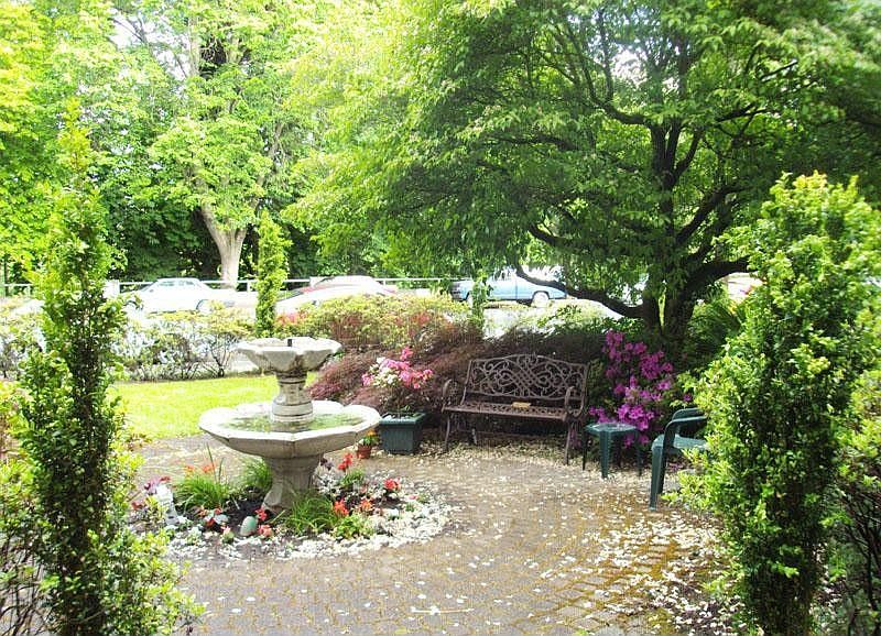 Quaint seating area with abundant foliage