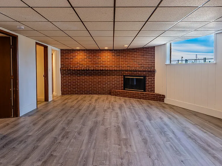 Statement brick fireplace in open concept living and dining with Puget Sound views