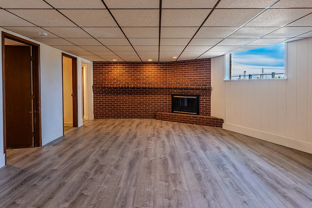 Statement brick fireplace in open concept living and dining with Puget Sound views - 9922 Triton Dr NW #1/2