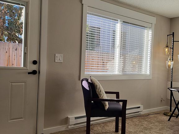 Large windows with new white blinds.