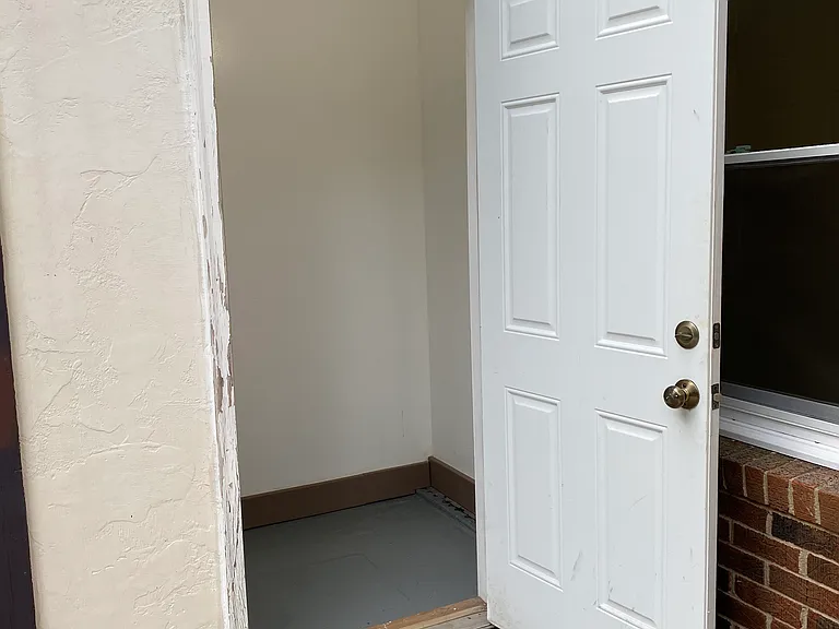 Deadbolt secured back patio insulated storage shed with light and outlets.