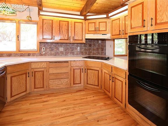 Updated kitchen, new hardwood, built-in double ovens, glass cook top, corian cou