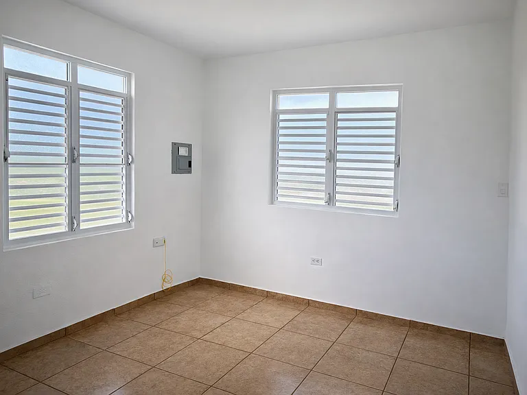 Bright and airy bedroom with large windows for plenty of natural light.