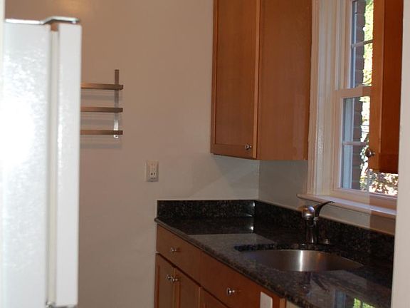 kitchen with granite counter tops, gas stove and 42" cabinets