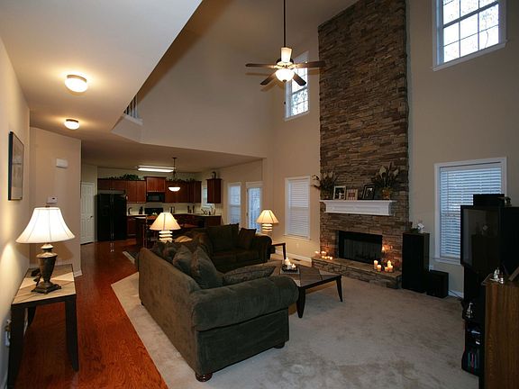 Two story family room with floor to ceiling stacked stone fireplace