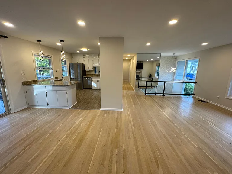 Upstairs view of dining area next to living room and kitchen.