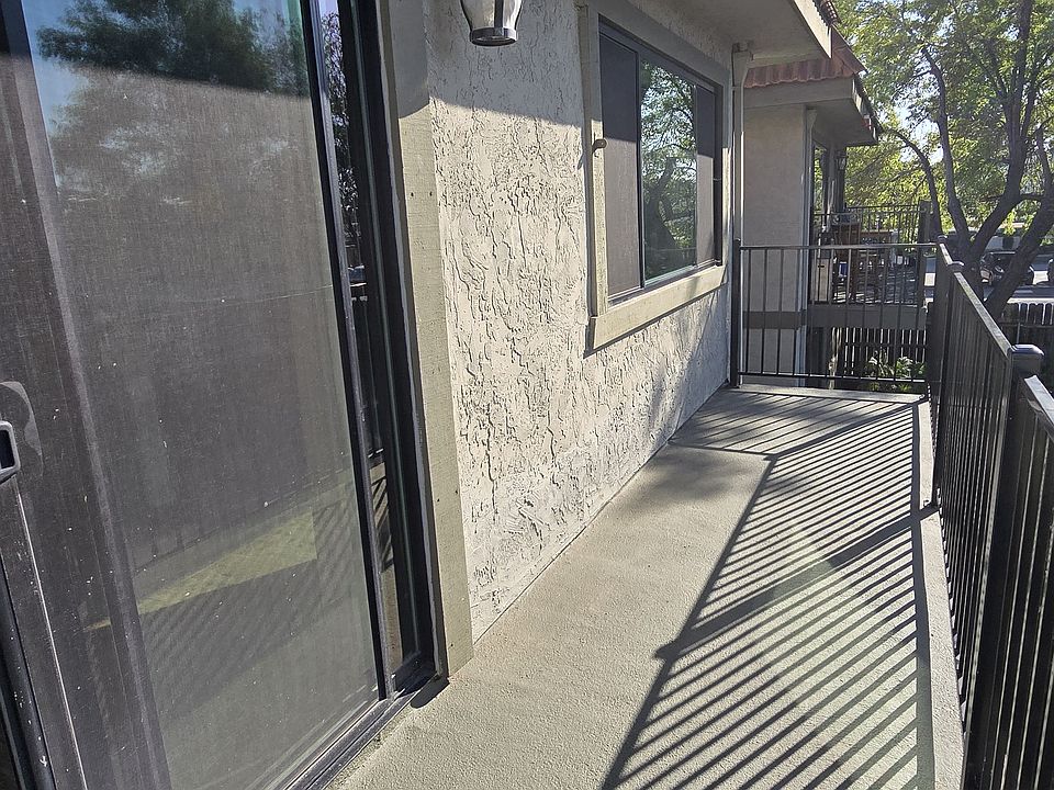 Enjoy your morning coffee or unwind at sunset on the private front balcony, offering a peaceful view of the neighborhood and space for small outdoor seating.