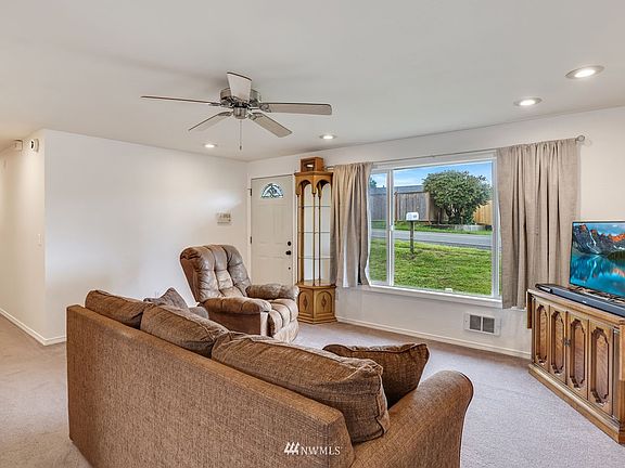 Spacious living room with large picture window boasting an abundance of natural light. 