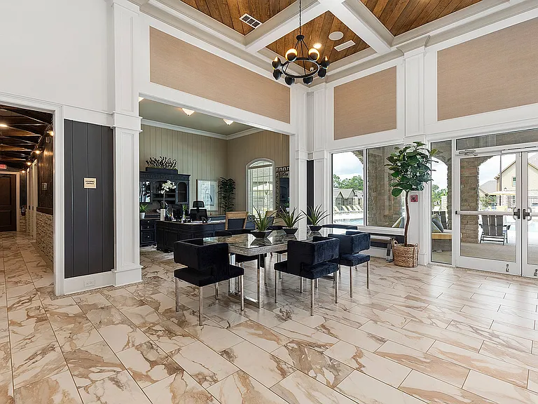 Luxurious lobby featuring elegant marble flooring, modern furniture, and a welcoming reception area with views of the outdoor pool.