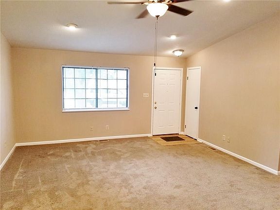 Another look at the large great room complete with a coat closet and ceiling fan....