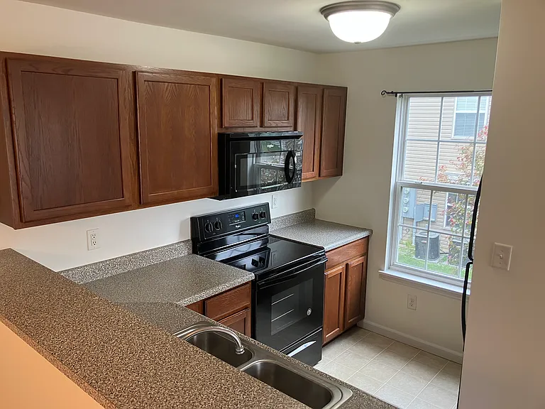 Kitchen offers a microwave, stove, dishwasher, and refrigerator.