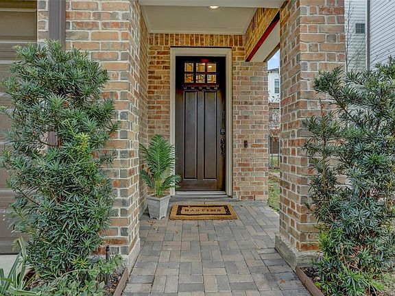 The brick entry welcomes you home.A ring doorbell and keyless entry can be activated remotely.